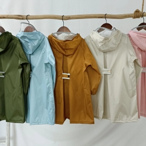 5 cortavientos de diferentes colores en un perchero de madera